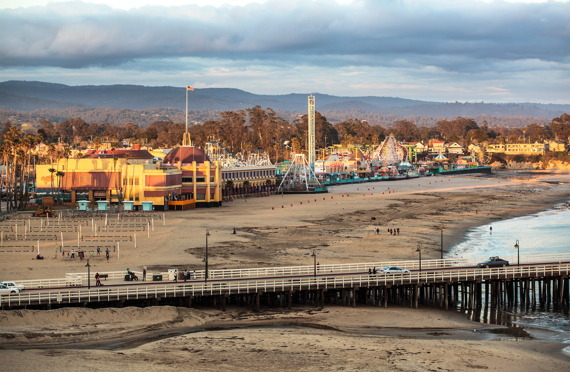Golden evening light over the Santa Cruz Beach Boardwalk, Main Beach, and Wharf